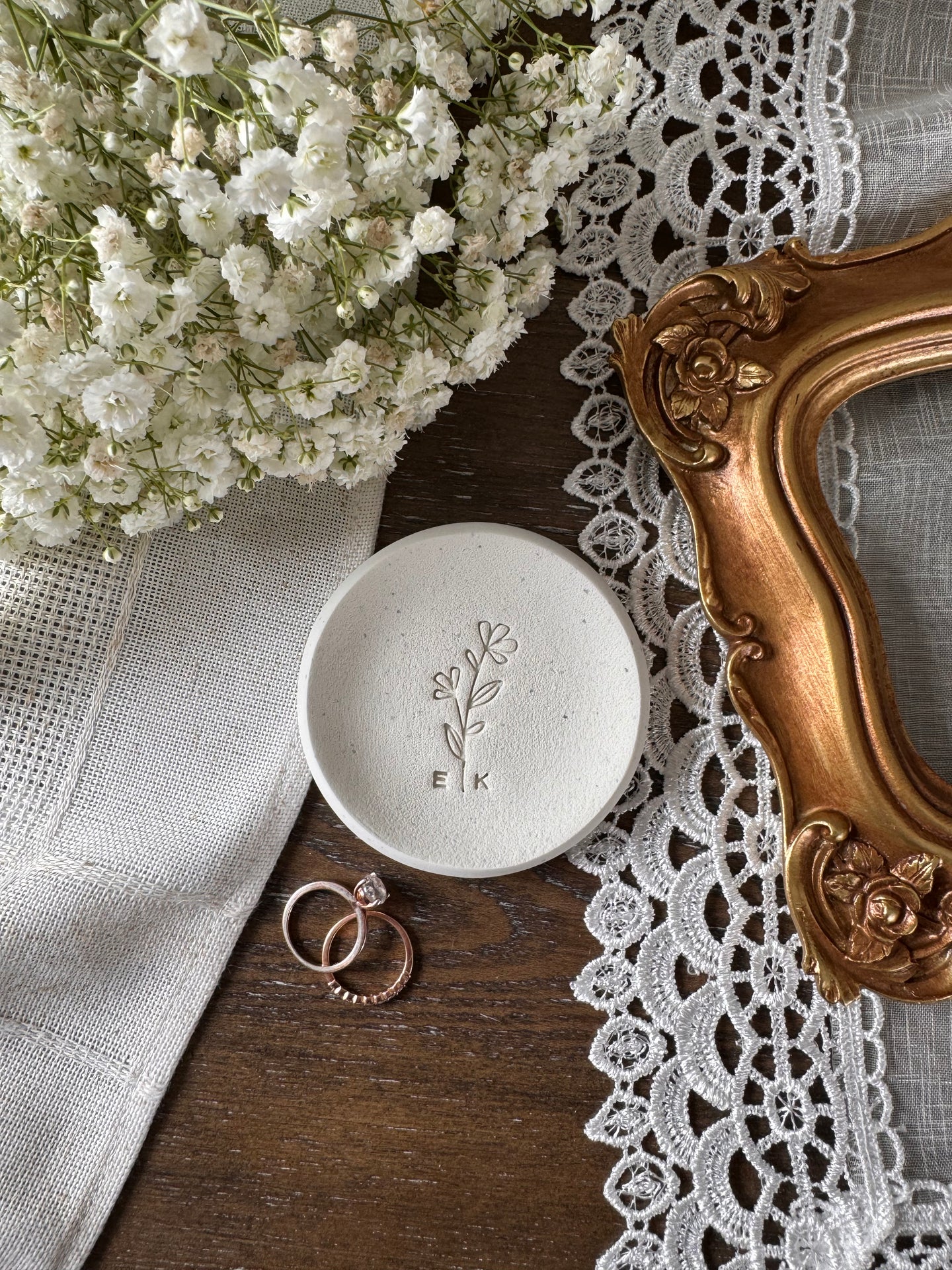 ring dish with simple floral design and personalized initials in center of dish, white clay